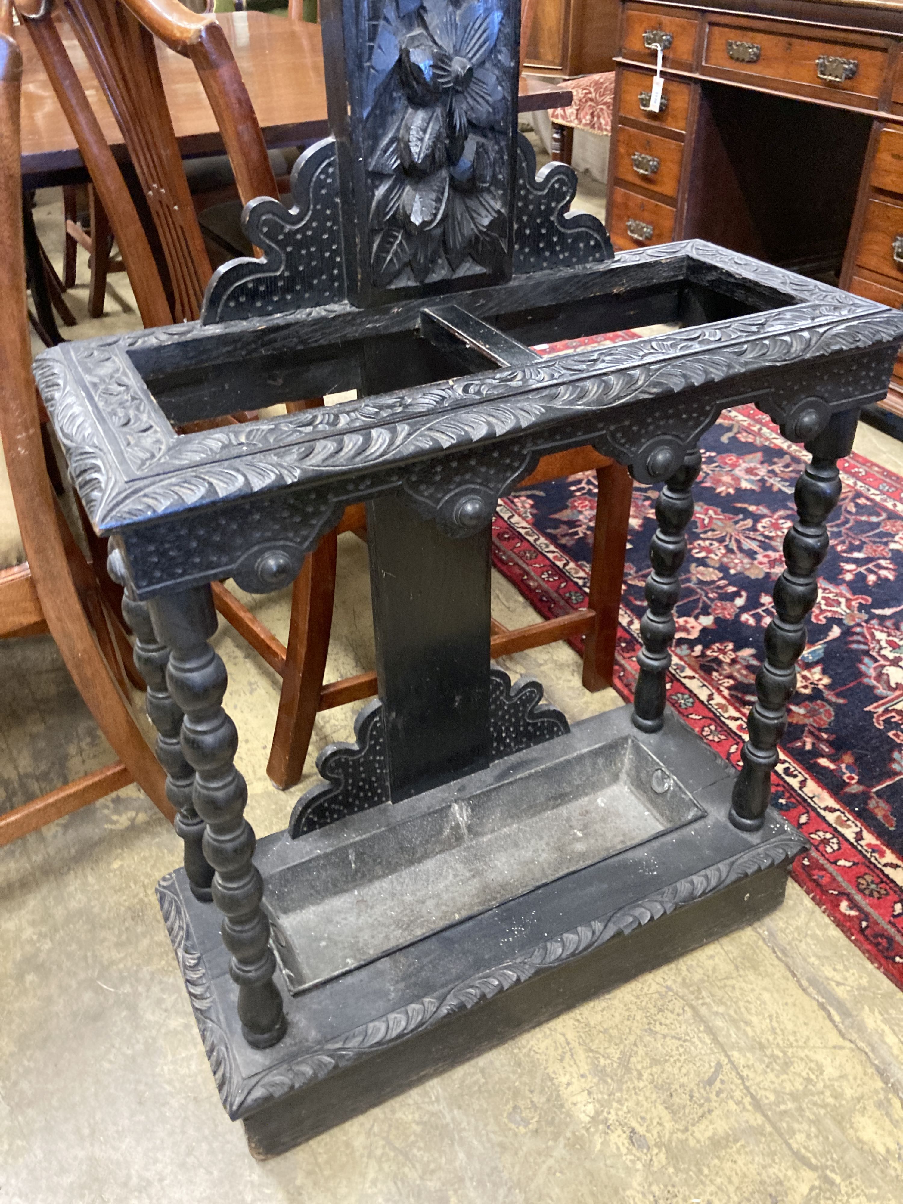 An early 20th century Flemish carved oak hall stand, width 60cm, depth 25cm, height 208cm